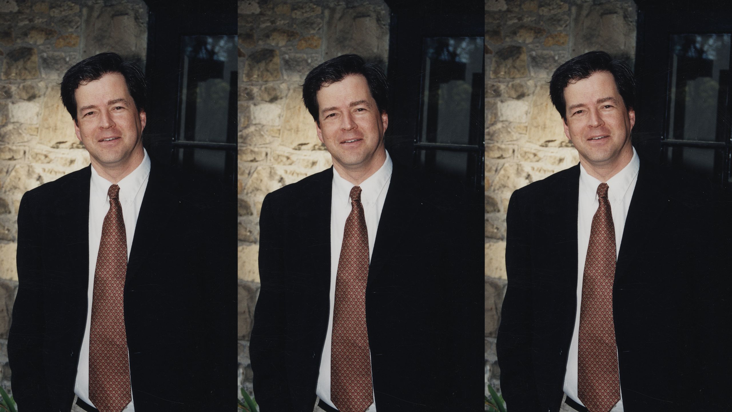 Andrew McGowan standing wearing a tie