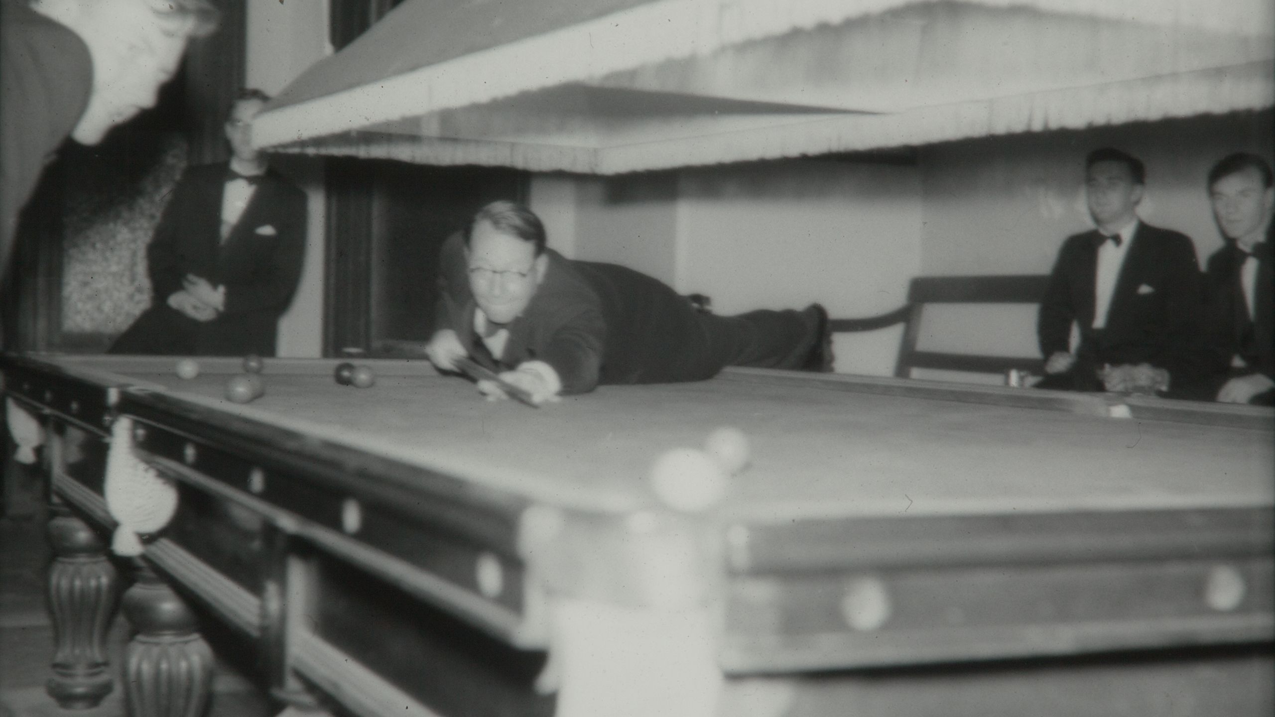 Black and white photo of Ronald Cowan playing pool