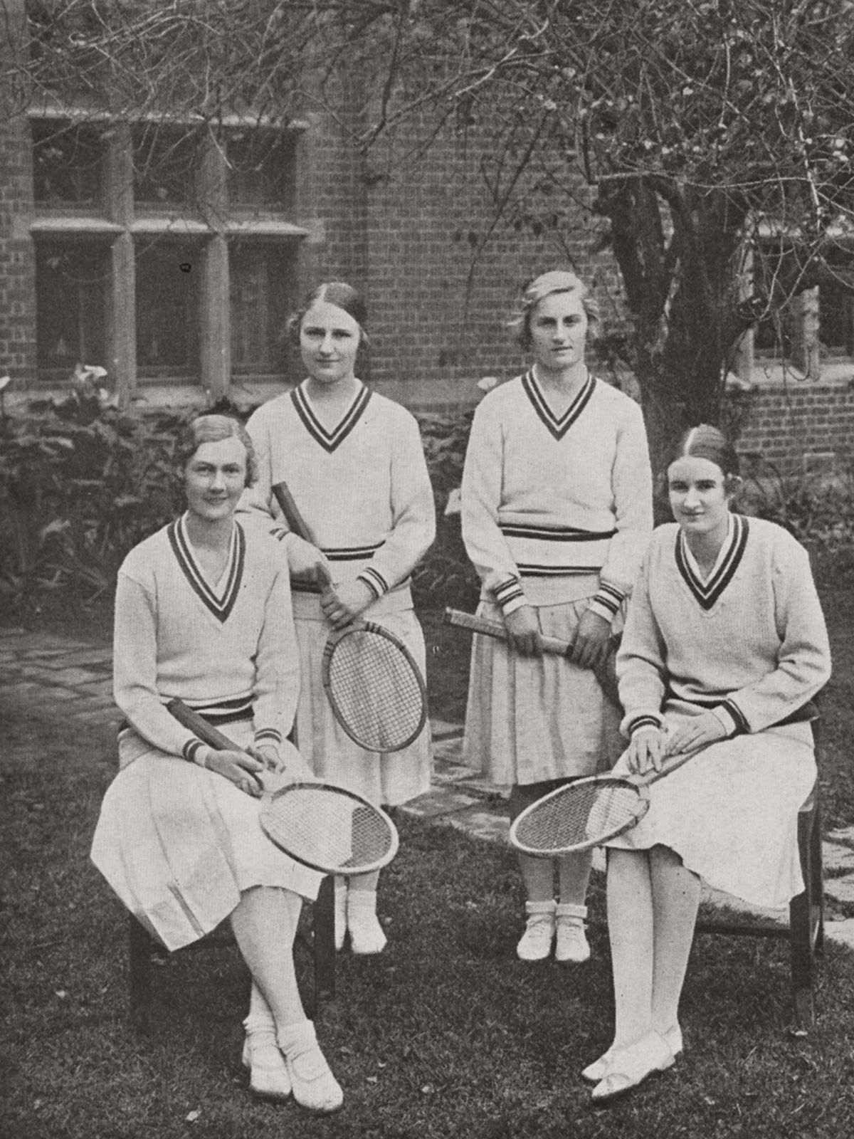Four women students wearing cream woolen tennis attire, 1931.
