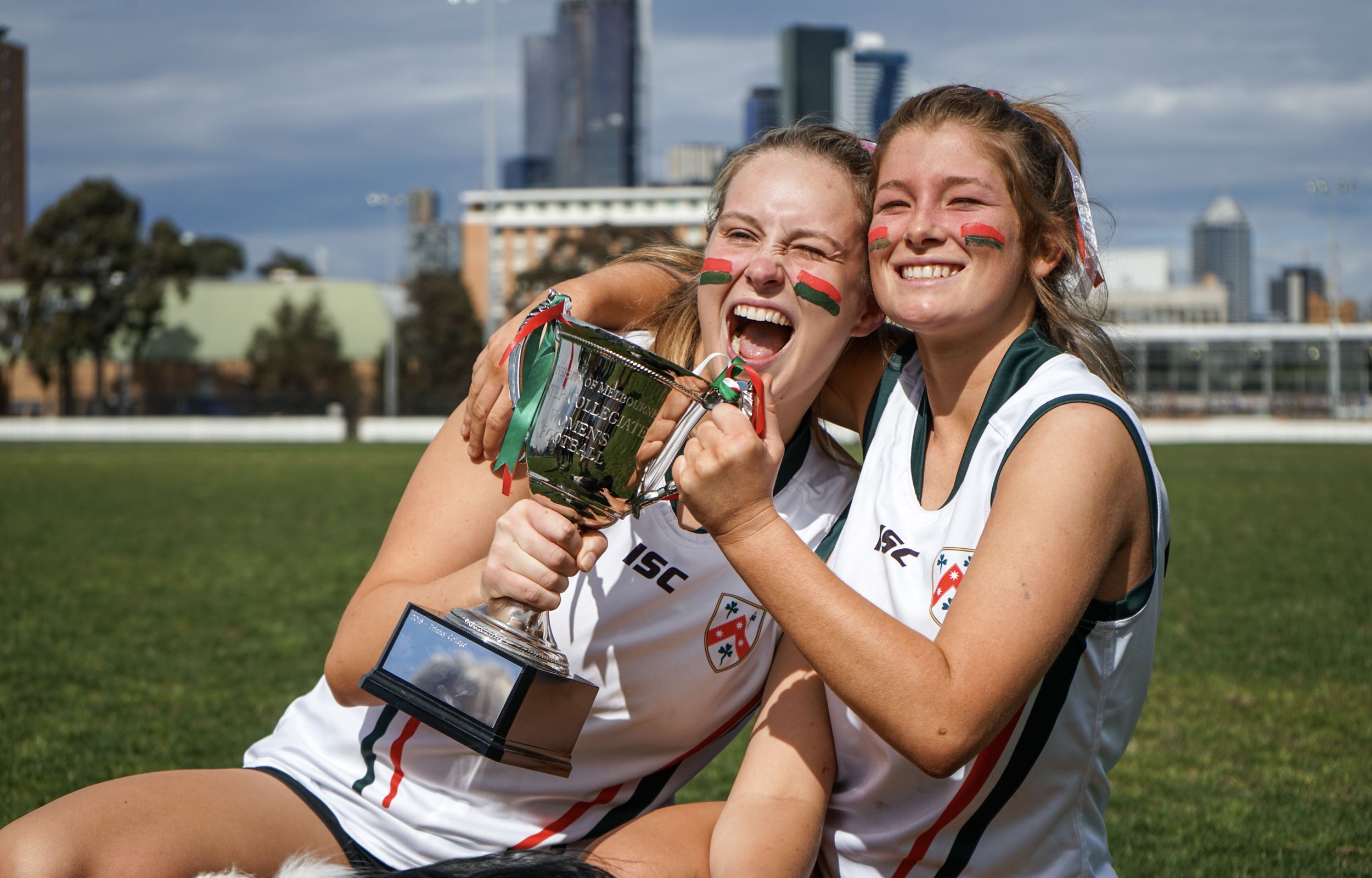 Lucy Leckey (TC 2017; left) with Emma Nelson (TC 2018) celebrating on the University Oval after a fantastic win by the women's football team.