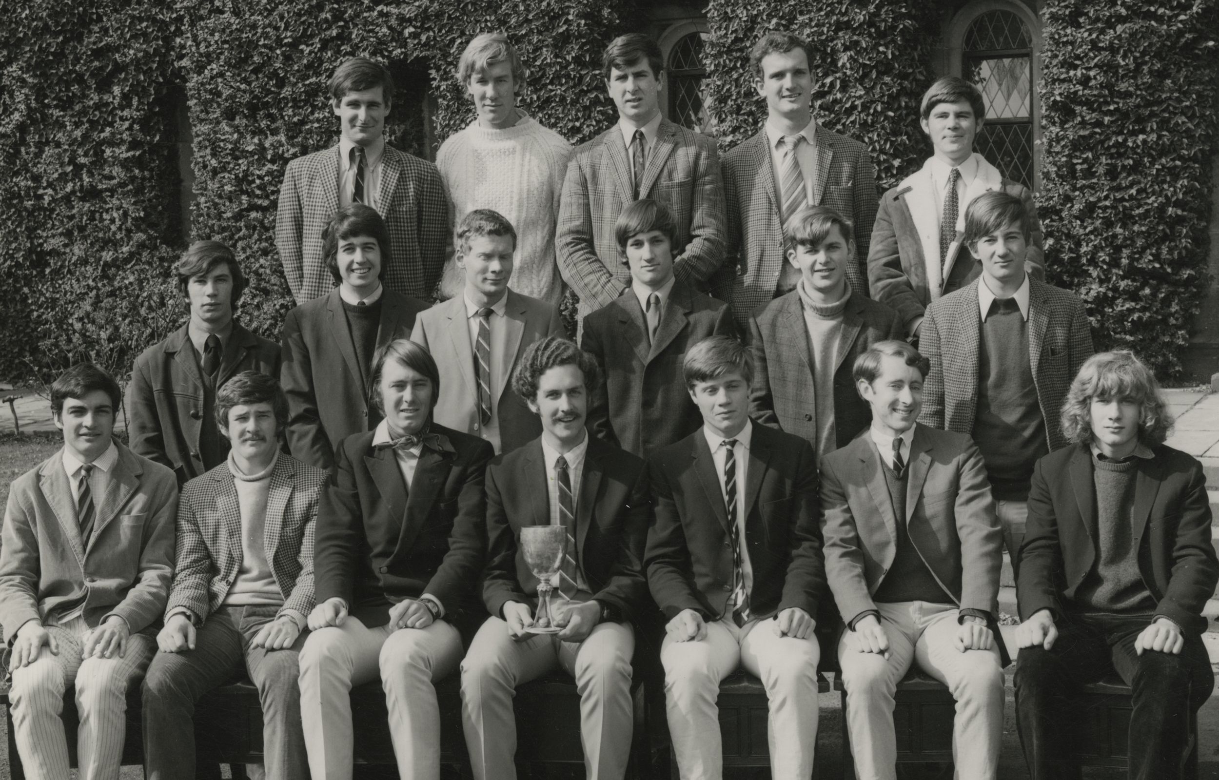 The College rugby team, all smiles - with a trophy in their lap, 1971.