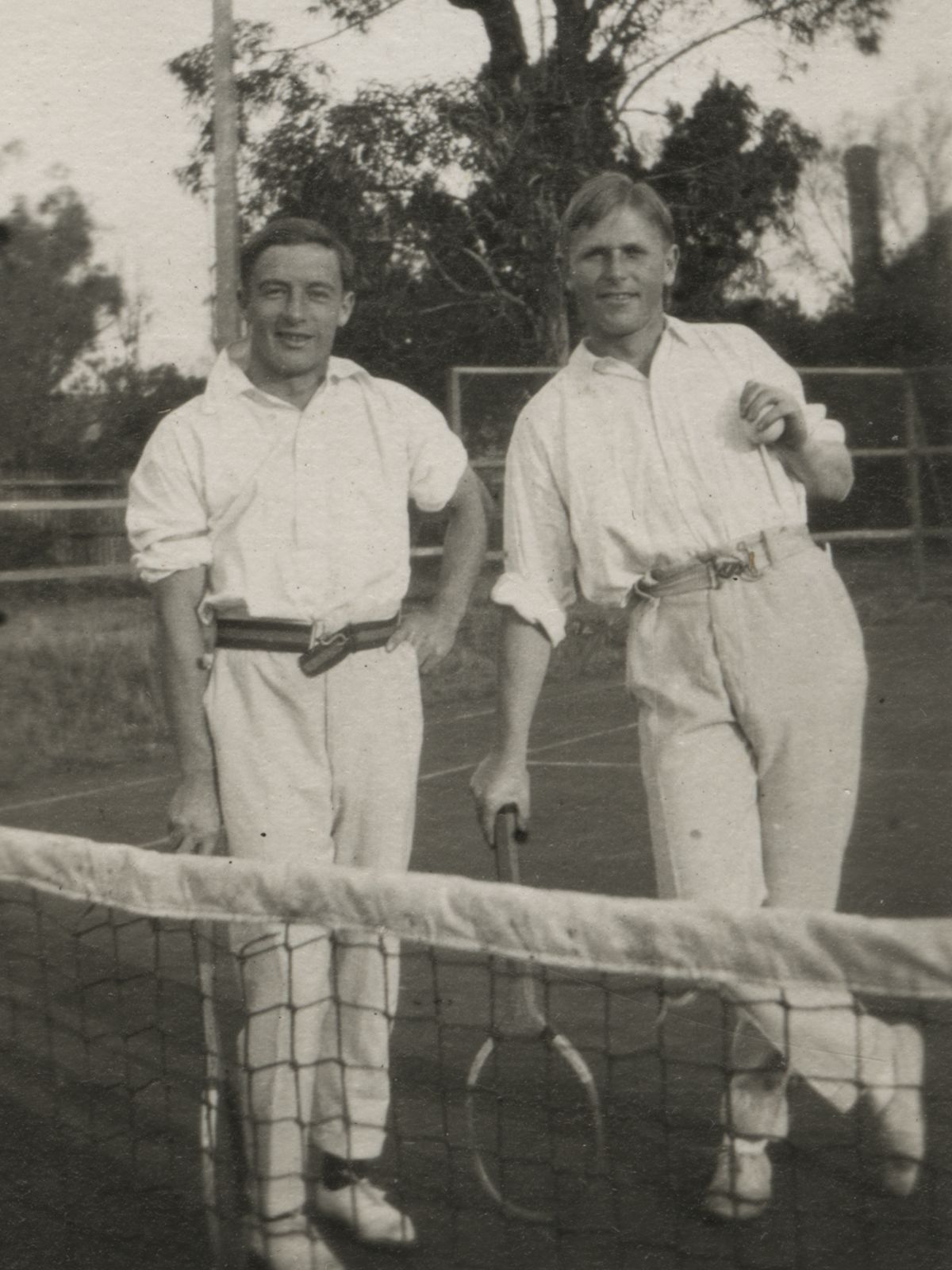 Two College 'gentlemen' pose for the camera on the old tennis court along Tin Alley, c. 1920.